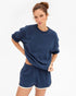 Clare Vivier navy oversized short sleeve sweatshirt on model, casual style against white backdrop.