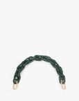 The Shortie Strap by Clare Vivier is a dark green resin chain with thick links and gold clasps, arranged in a semi-circle on white. Ideal for bag accessories, this strap adds flair to any ensemble with its unique design.