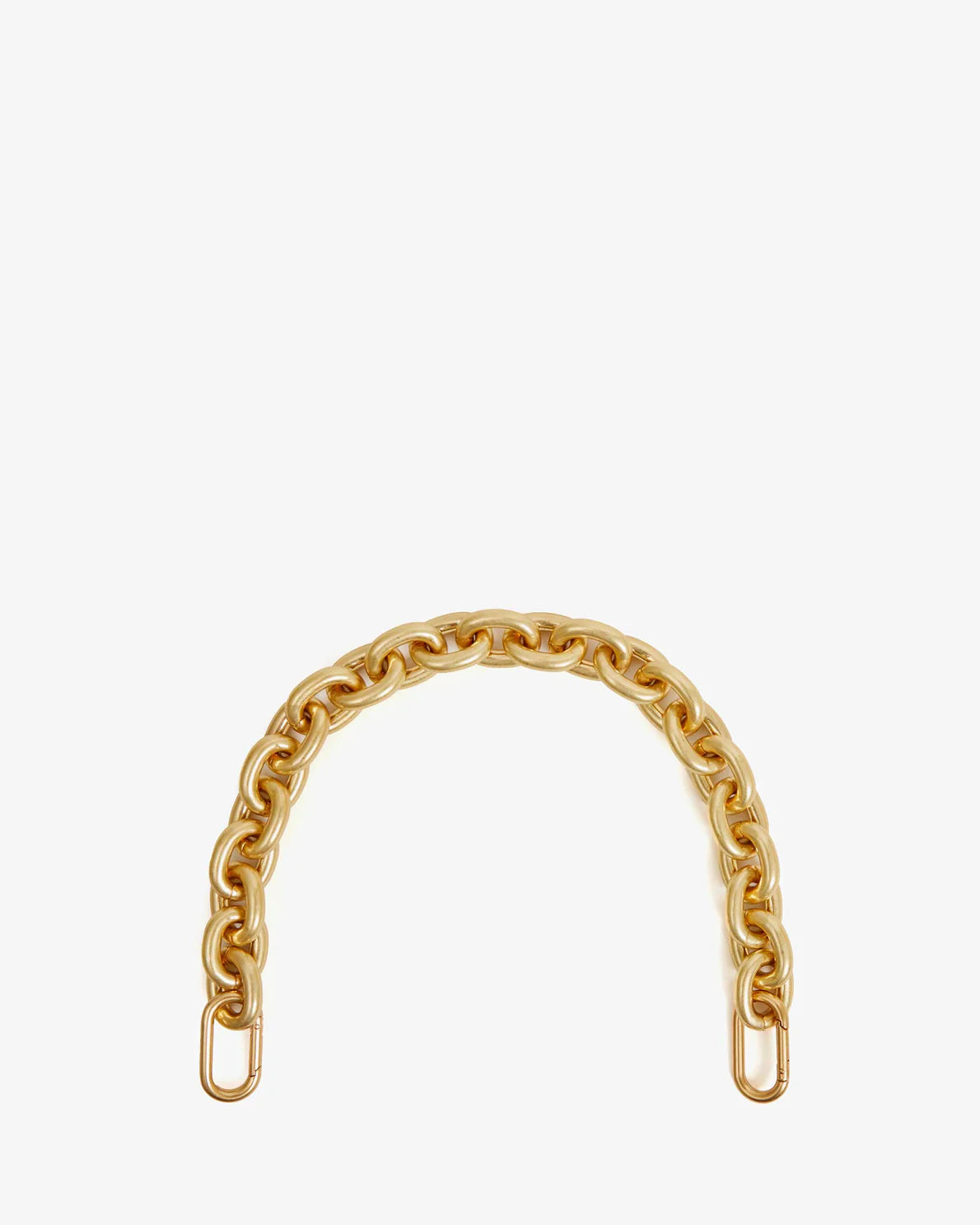 A single, gold-toned chain forming a semi-circle against a white background. The ends of the 17" long Clare Vivier Shortie Strap have brass spring links, distinct from the smaller, interlocking circular links that make up the remainder of the chain.