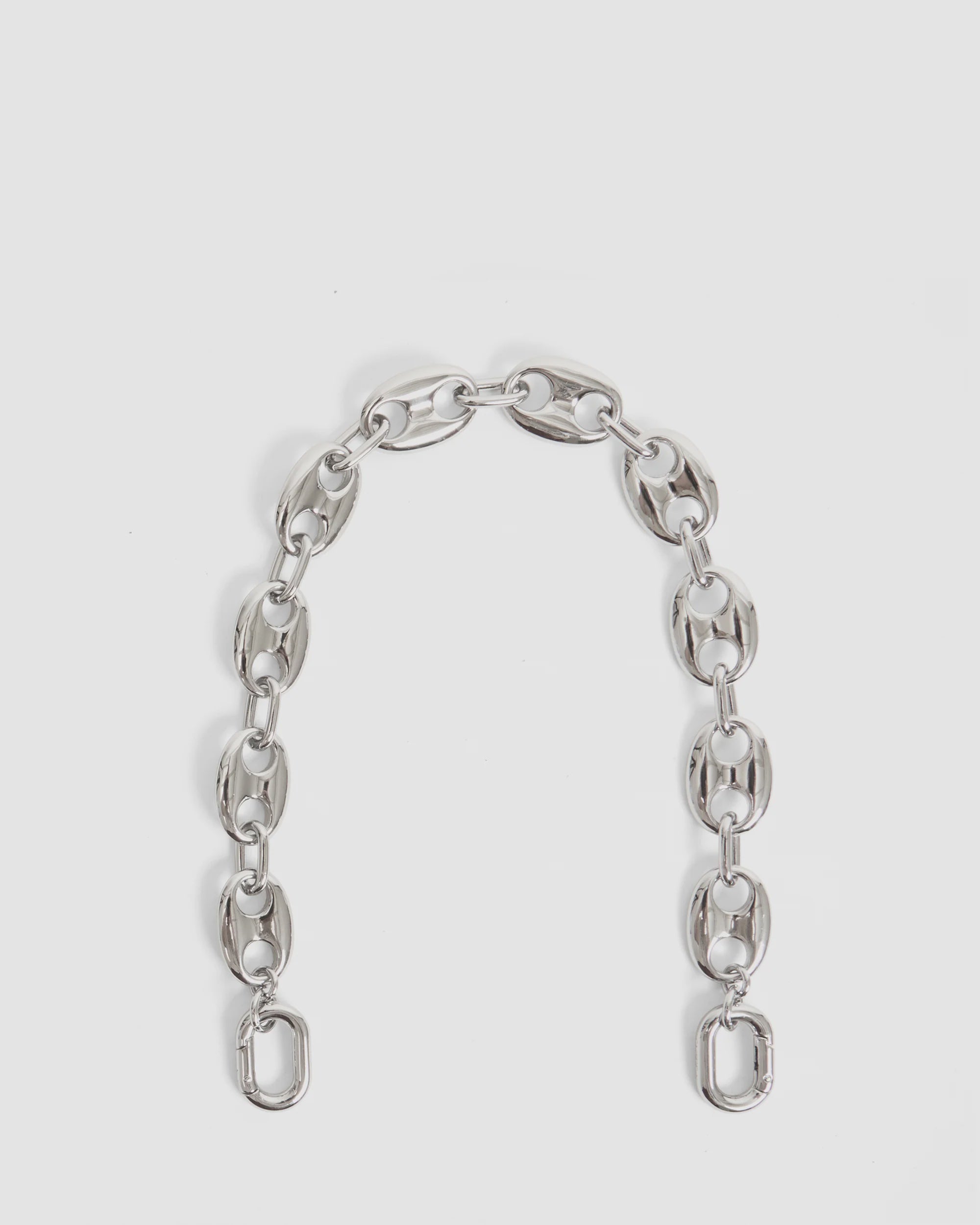 The Clare Vivier Shortie Strap/Mariner Chain features large oval and rectangular links in a gently curved, short and thick rhodium-plated design, shown on a plain white background.