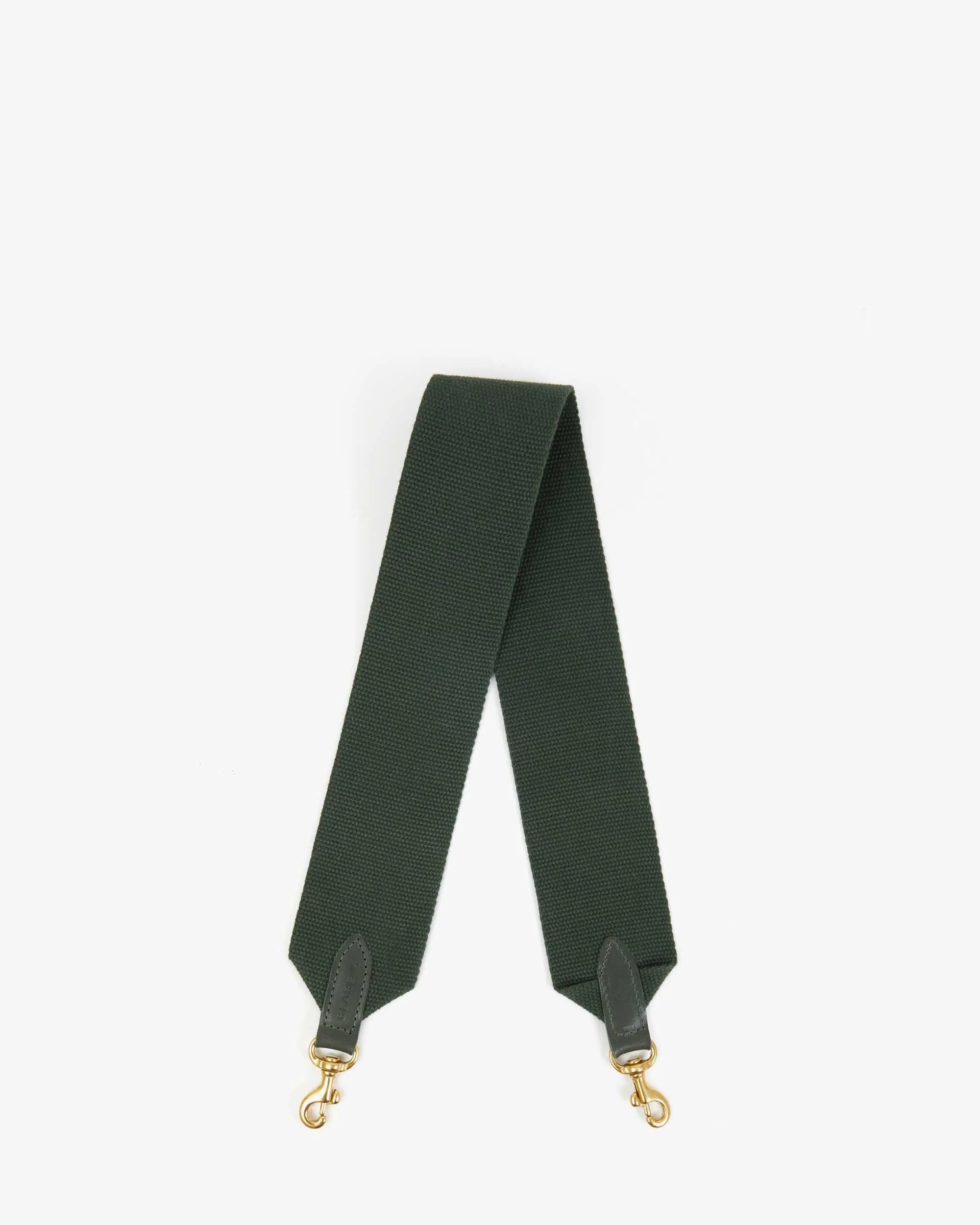 The Clare Vivier Shoulder Strap is a dark green cotton webbing strap with black leather ends and gold metal clasps, crafted in L.A. as a stylish replacement for your shoulder bag, displayed flat against a white background.