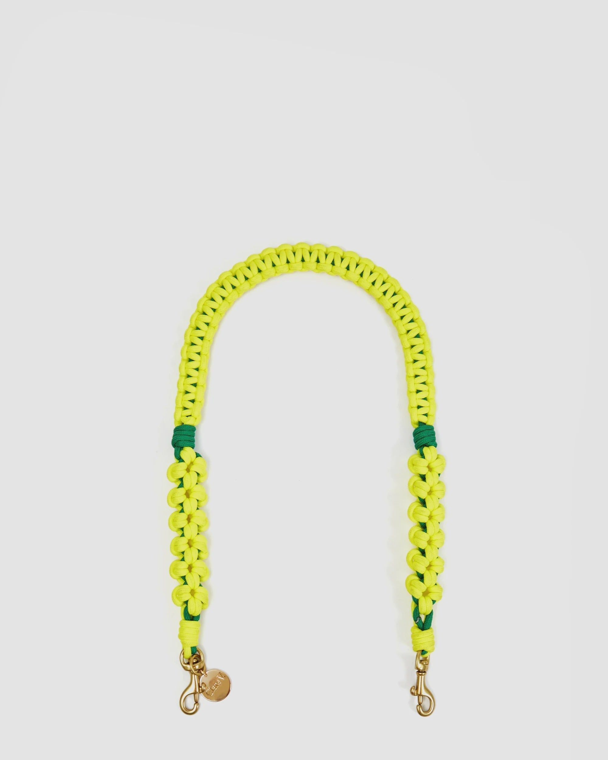 The Clare Vivier Shoulder Strap S25 is a 26.5-inch neon yellow braided Sailcord strap with two metal clasps and a small round charm, shown in a U-shape on a white background—perfect as a sporty bag accessory.