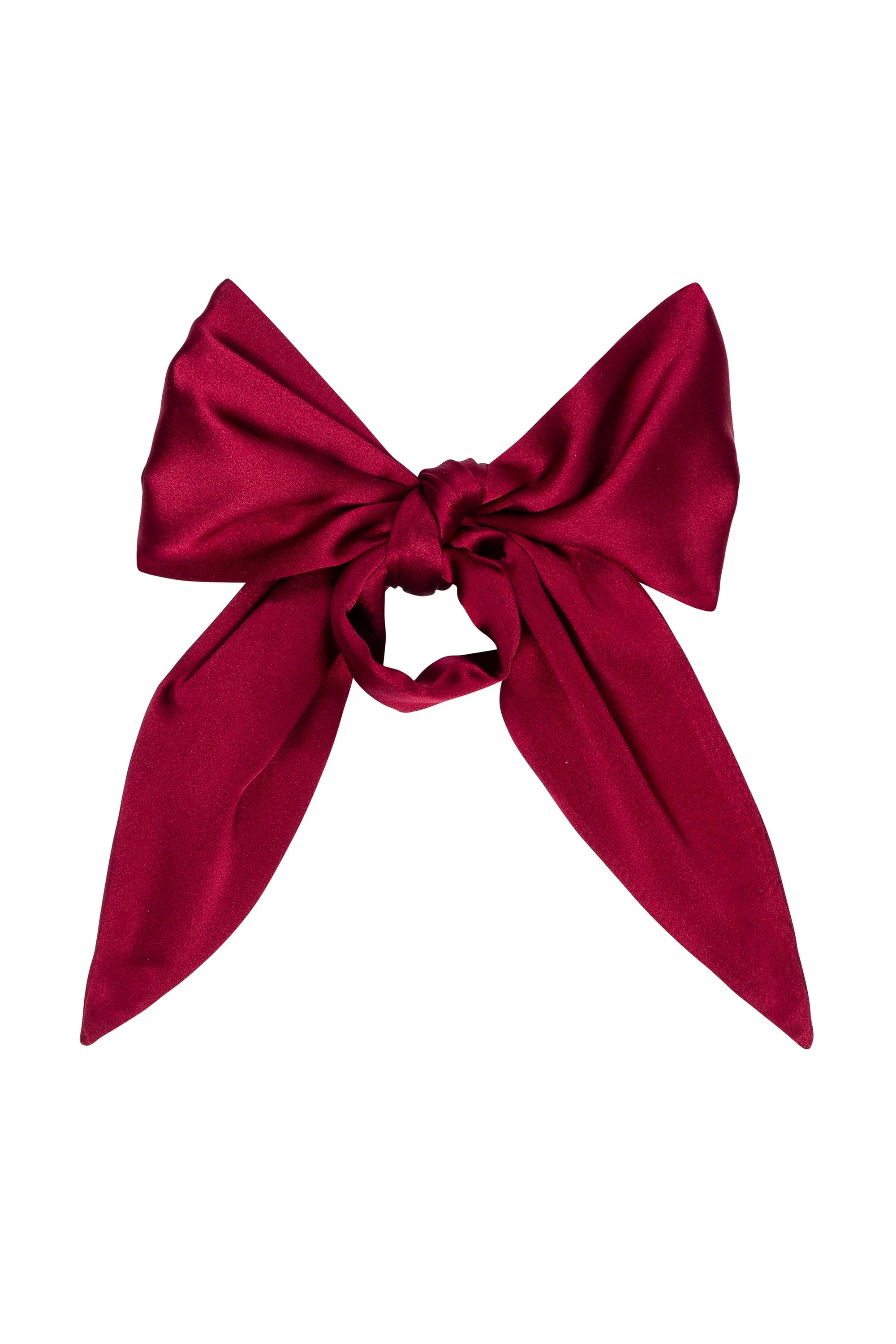 The Silk Bow by Donni is a large, deep red 100% silk accessory with wide loops and long tails, shown on a white background—perfect for elegant occasions.