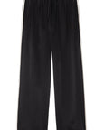 The Silk Stripe Crop Pant by Donni features a black wide-leg design with a drawstring waist and white side stripes, crafted from luxurious silk fabric.