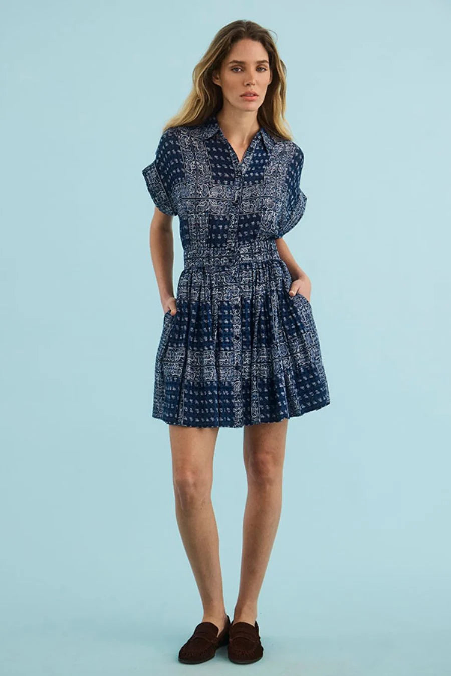 Blue patterned Howard Dress with elastic waist and pockets by Hunter Bell NYC on a light blue background.