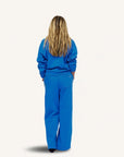 Blue Kerri Rosenthal super soft fleece shrunken sweatshirt and pants set modeled by person with long blonde hair.