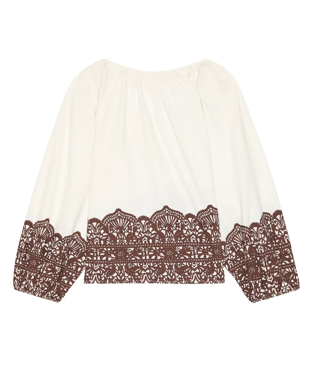The Chariot Top is a white textured cotton long-sleeve top with a loose fit and detailed brown lace accents on the hem and cuffs.