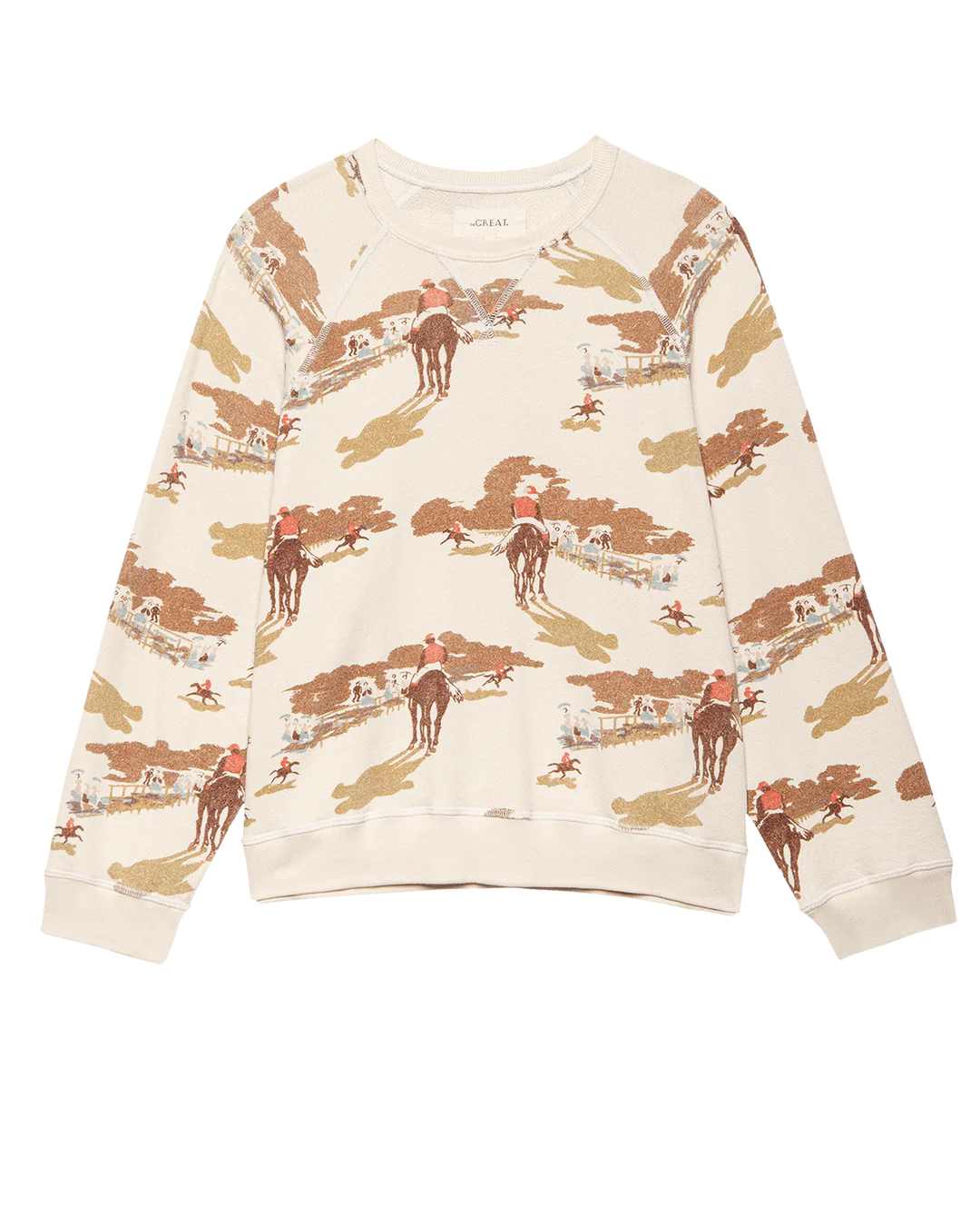 The Slouch Sweatshirt by The Great Inc. is a cream-colored top with an all-over print of cowboys on horseback riding through a western landscape, featuring trees and buildings in brown, red, and tan for a vintage-inspired look.