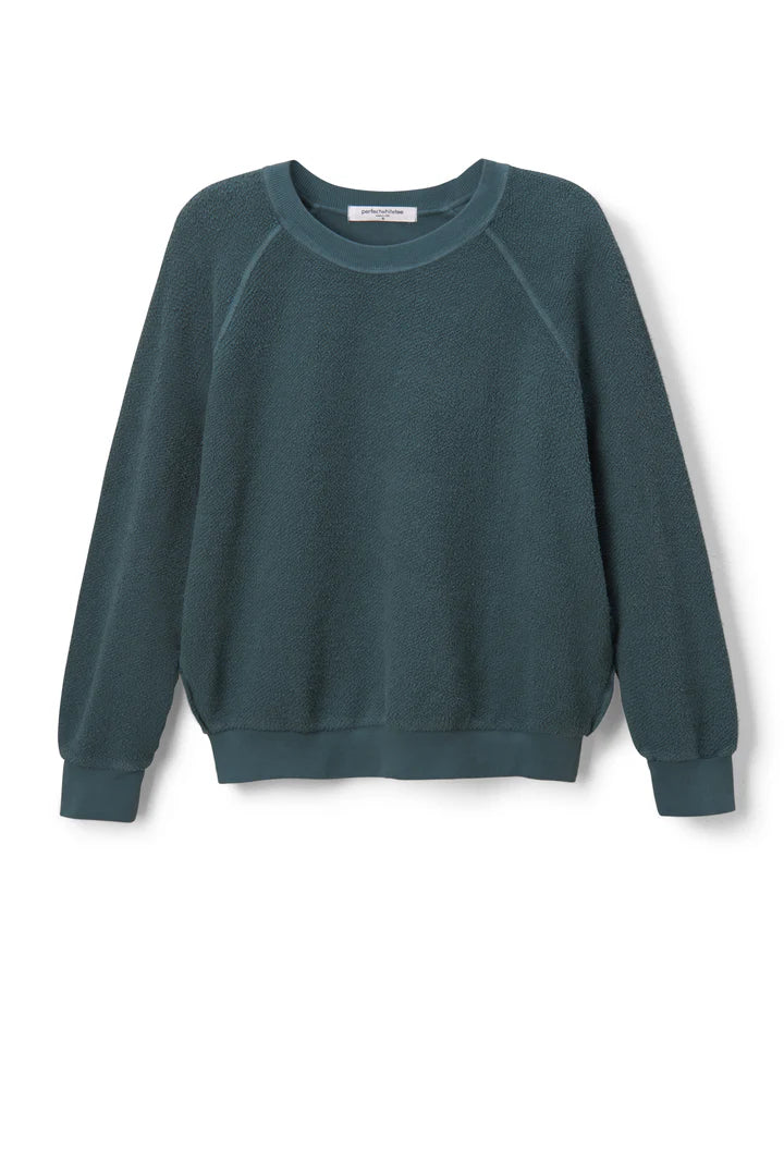 The Ziggy Reverse LS Sweatshirt by Perfectwhitetee in teal features bracelet-length sleeves, ribbed cuffs and hem, and is made from soft, textured cotton fleece. Displayed against a plain white background.