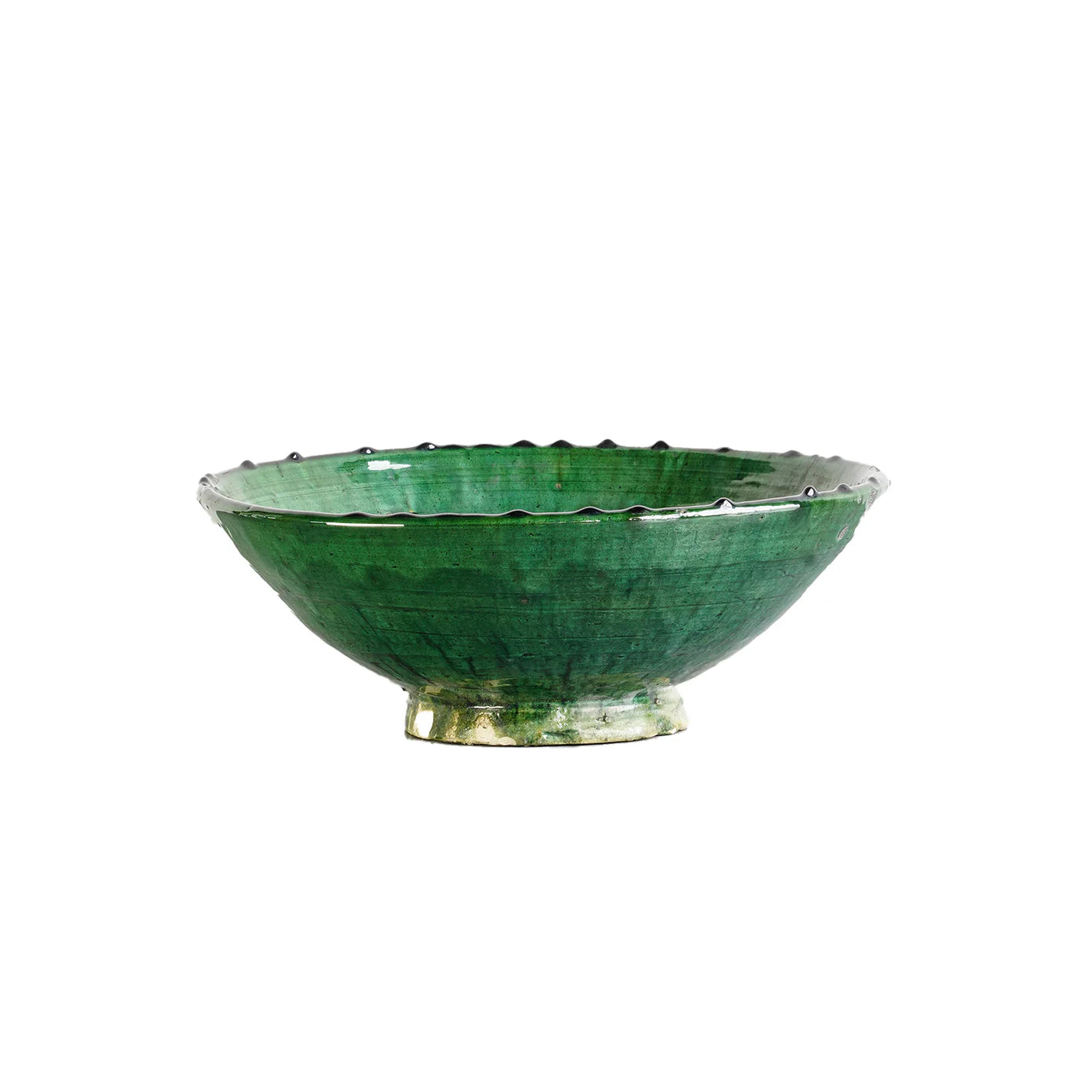 The Tamegroute Bowl by Blue Ocean Traders features a wide, shallow shape, glossy green glaze, and scalloped rim. Hand-shaped for a unique decorative accent, it is shown on a white background.