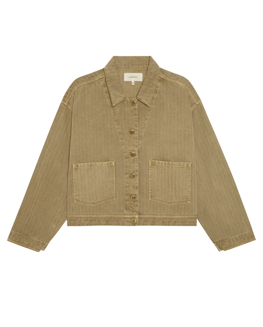 The Great Inc. Rancher Jacket in tan, made from cotton herringbone denim with long sleeves, a collar, and two front pockets, shown flat on white for a timeless vintage workwear look.