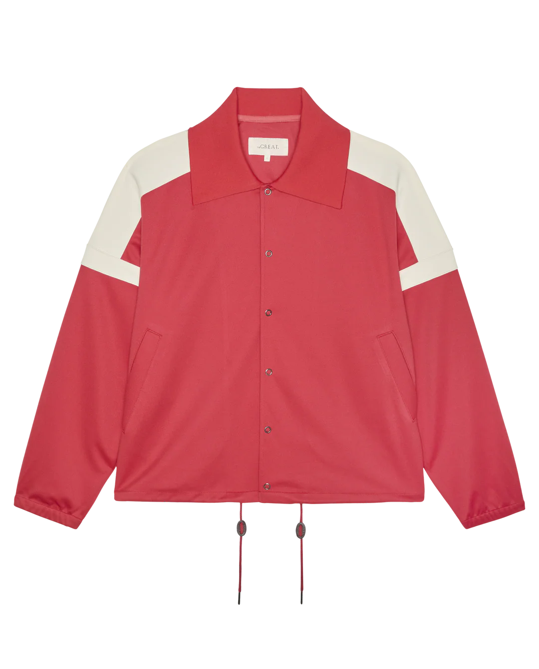 The Trainer Jacket by The Great Inc. is a red vintage-inspired sport jacket featuring white shoulder accents, a large collar, snap button closure, two front pockets, and hem drawstrings.