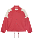 The Trainer Jacket by The Great Inc. is a red vintage-inspired sport jacket featuring white shoulder accents, a large collar, snap button closure, two front pockets, and hem drawstrings.