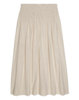 The Viola Skirt by The Great Inc. is a beige, knee-length skirt with a gathered smocked waistband and loose, pleated design, crafted from lightweight, textured shadow stripe cotton.