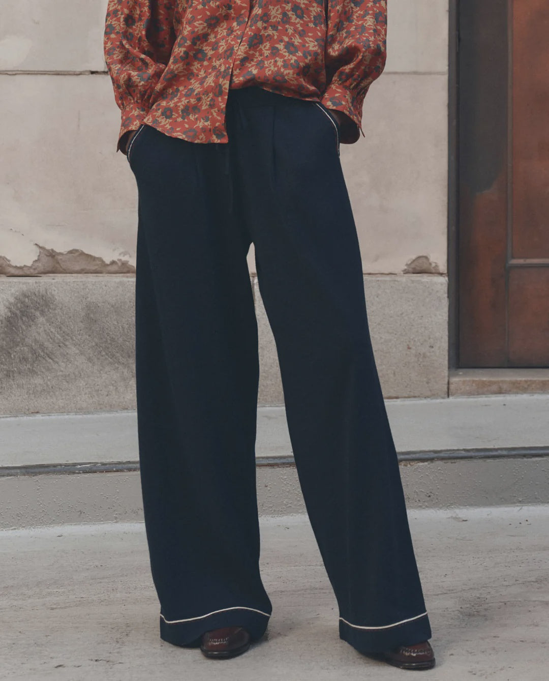 The Great Inc. Menswear Tipping Trouser styled with a red patterned shirt, sidewalk setting.
