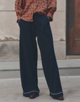 The Great Inc. Menswear Tipping Trouser styled with a red patterned shirt, sidewalk setting.