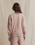 The Great Inc. College Sweatshirt 2026 in beige, shown from the back against a neutral fabric backdrop.
