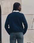 The Fleece Rookie Growling Panther jacket by The Great Inc. worn outdoors, back view, braided hair visible.