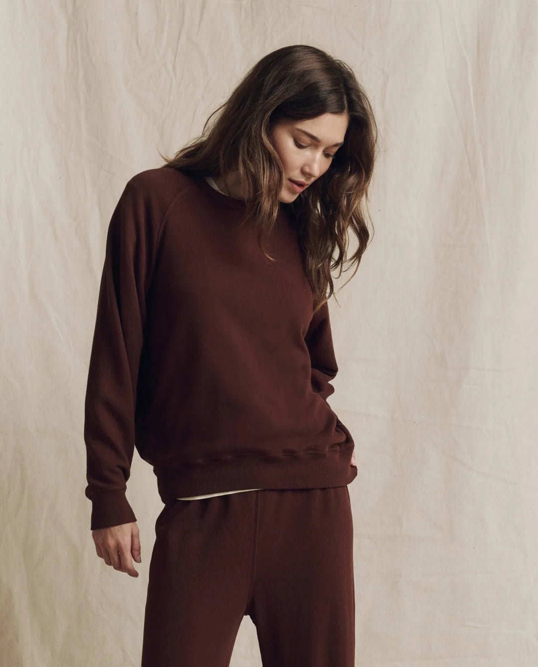 The Great Inc. College Sweatshirt 2026 in a neutral setting, modeled with relaxed, casual style.