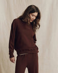 The Great Inc. College Sweatshirt 2026 in a neutral setting, modeled with relaxed, casual style.