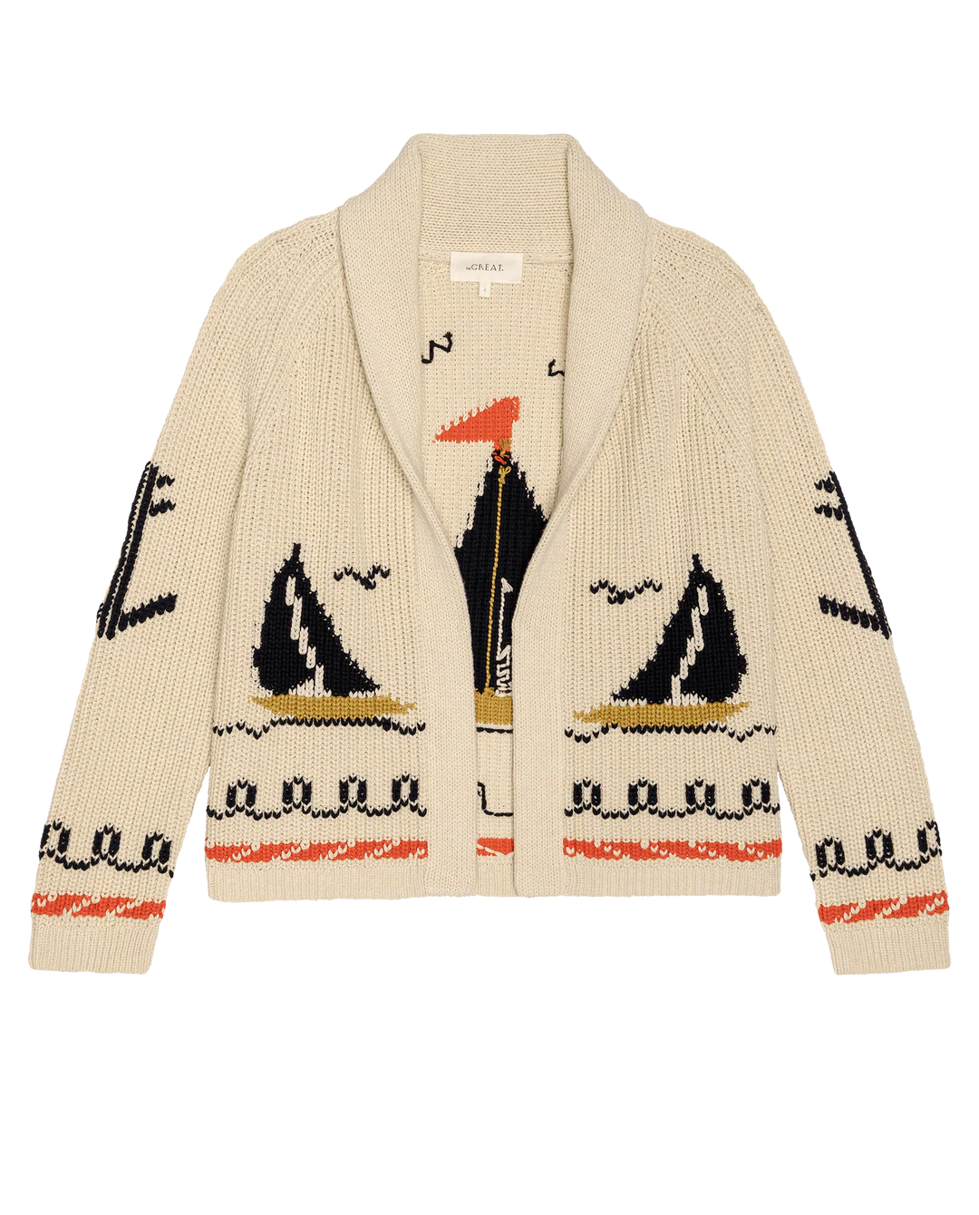 The Great Inc. Sailboat Lodge Cardigan is a cream-colored cotton blend with hand-embroidered boats, black, orange, and gold seagulls, wave motifs, and decorative borders. Features a shawl collar and open front.