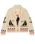 The Great Inc. Sailboat Lodge Cardigan is a cream-colored cotton blend with hand-embroidered boats, black, orange, and gold seagulls, wave motifs, and decorative borders. Features a shawl collar and open front.