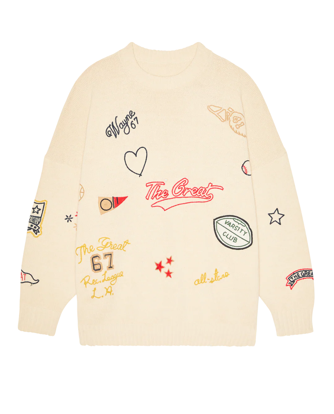 The Embroidered Oversize Crew by The Great Inc. is a cream cotton blend pullover, featuring colorful patch embroidery—stars, hearts, sports motifs, and varsity-inspired logos—for a playful take on vintage style.