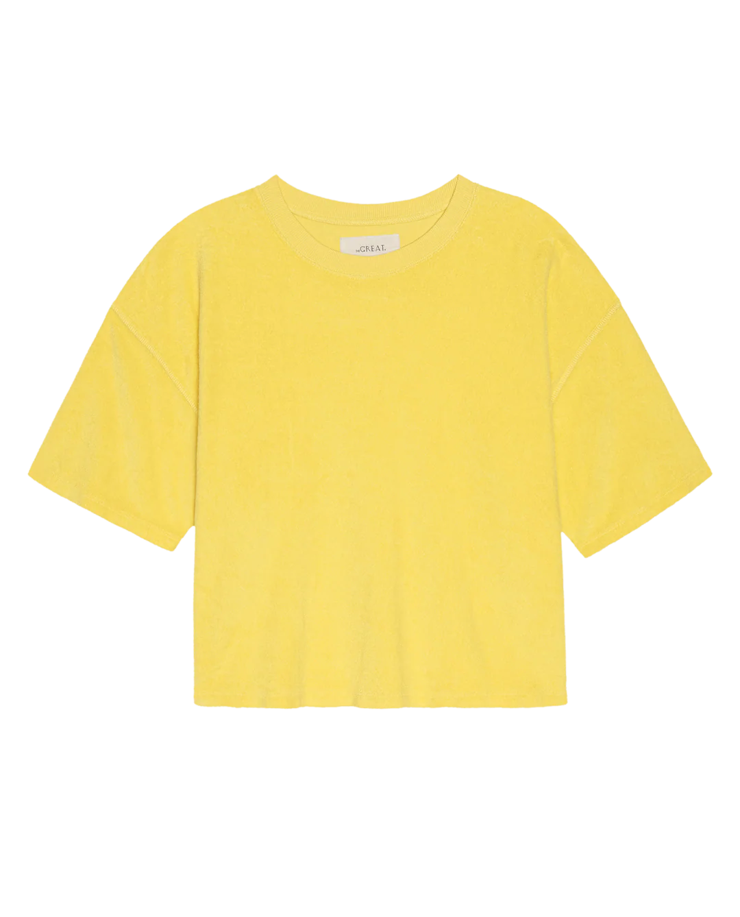 The Micro Terry Track Crew by The Great Inc. is a plain yellow short-sleeve T-shirt with a round neckline, crafted from soft cotton micro terry for a vintage athleticwear feel, shown on a white background.