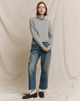 The Great Inc. Turtleneck paired with wide-leg blue jeans and dark loafers for a relaxed, classic look.