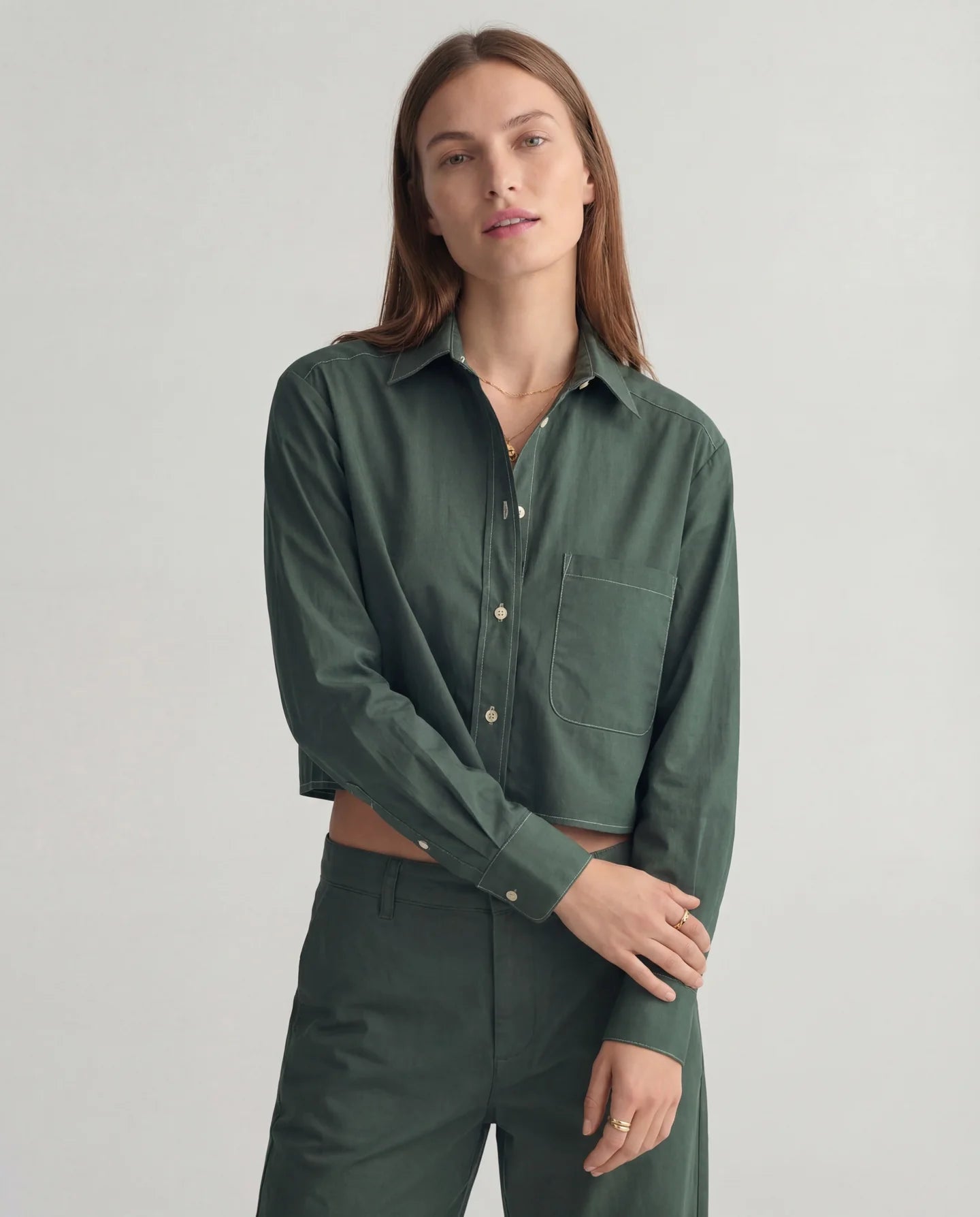 Dark green Harper Shirt and matching pants by THE SHIRT, worn by model against a plain light background.