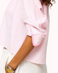 Kerri Rosenthal Tia Love Stripe Shirt with neon-pink trim, shown with white pants and yellow-faced watch.