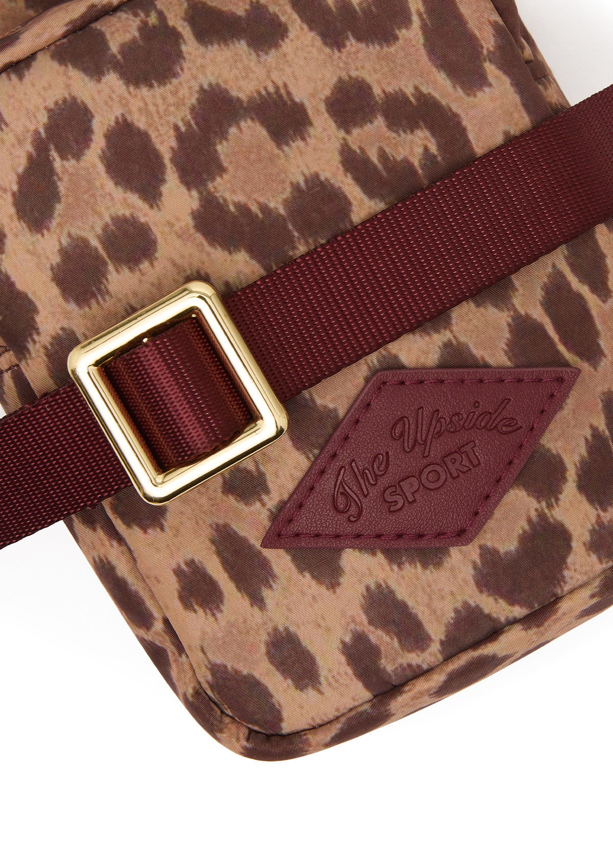 Leopard print crossbody bag with maroon strap and gold buckle by The Upside, recycled polyester.