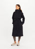 The Upside James hooded trench coat styled with patterned leggings and sneakers, casual modern look.