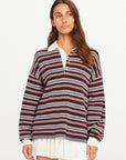 The Upside Wonder Knit Polo in cream with a white skirt, displayed against a plain white background.