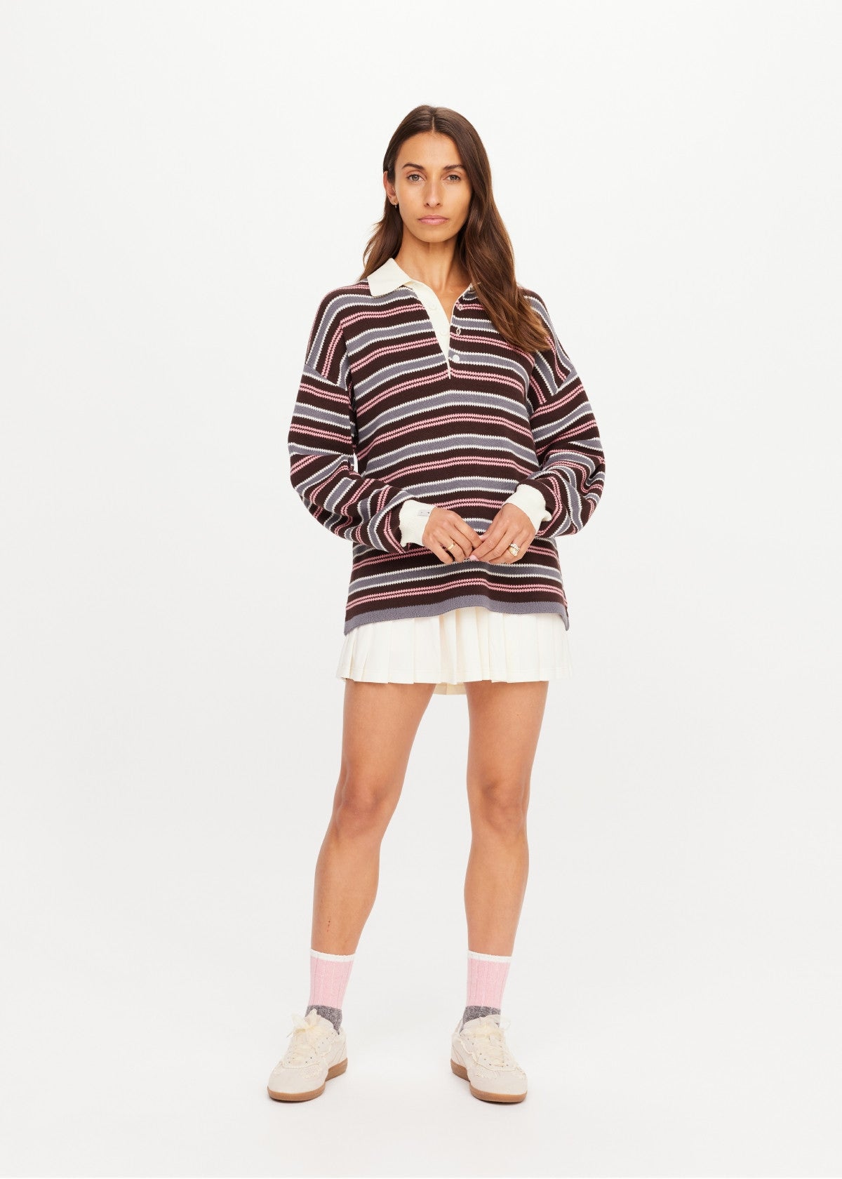 The Upside Wonder Knit Polo styled with a white pleated skirt and sneakers, casual look on white background.
