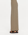 The Upside SANTOS ADRIEL SPLIT PANT in black, side view styled with black sandals.