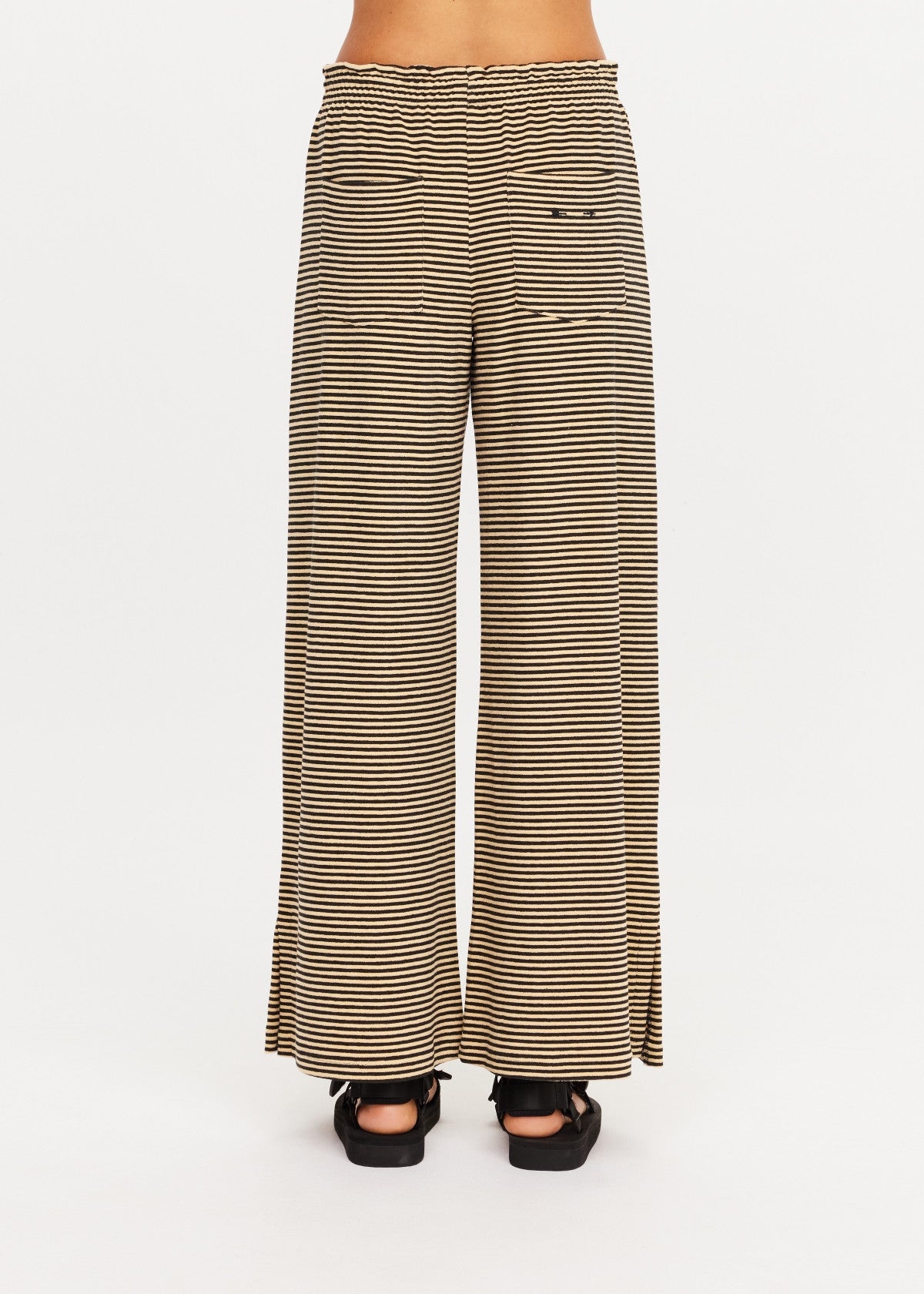 Cream and black striped Santos Adriel Split Pant by The Upside, shown from the back with black sandals.