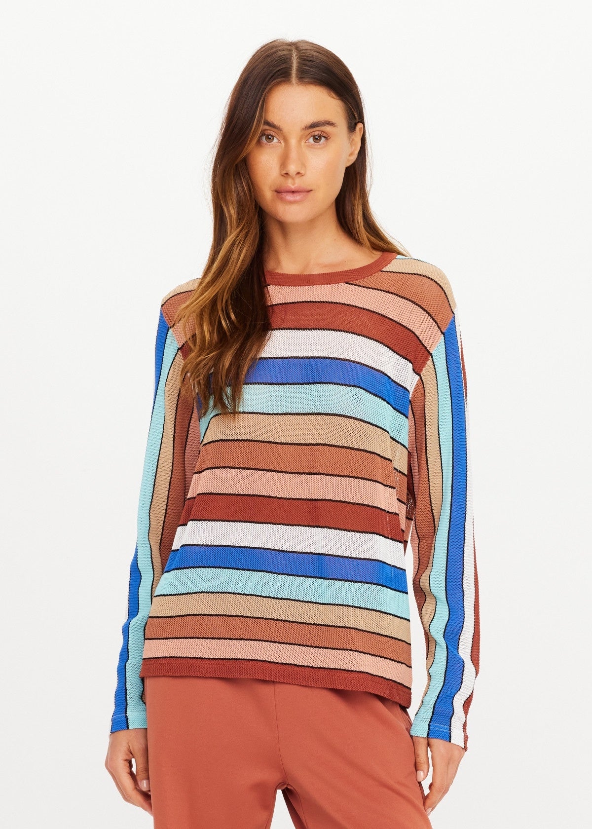 The Upside IZA MILLA long sleeve knit top in cream styled with rust pants, shown against a white background.