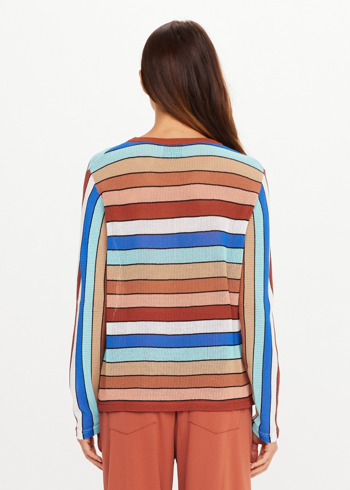 Multicolored striped long sleeve knit top by The Upside, styled with rust pants, model shown from the back.