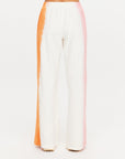 Orange-pink tie-dye wide leg pants in organic cotton from The Upside, viewed from the back.