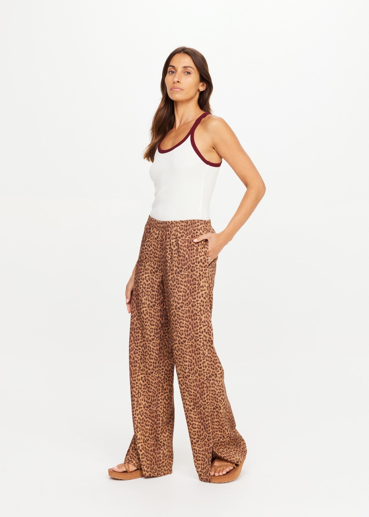 The Upside Javan Juliet Pant in classic black, paired with a white tank, modeled against a plain background.