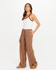 The Upside Javan Juliet Pant in classic black, paired with a white tank, modeled against a plain background.