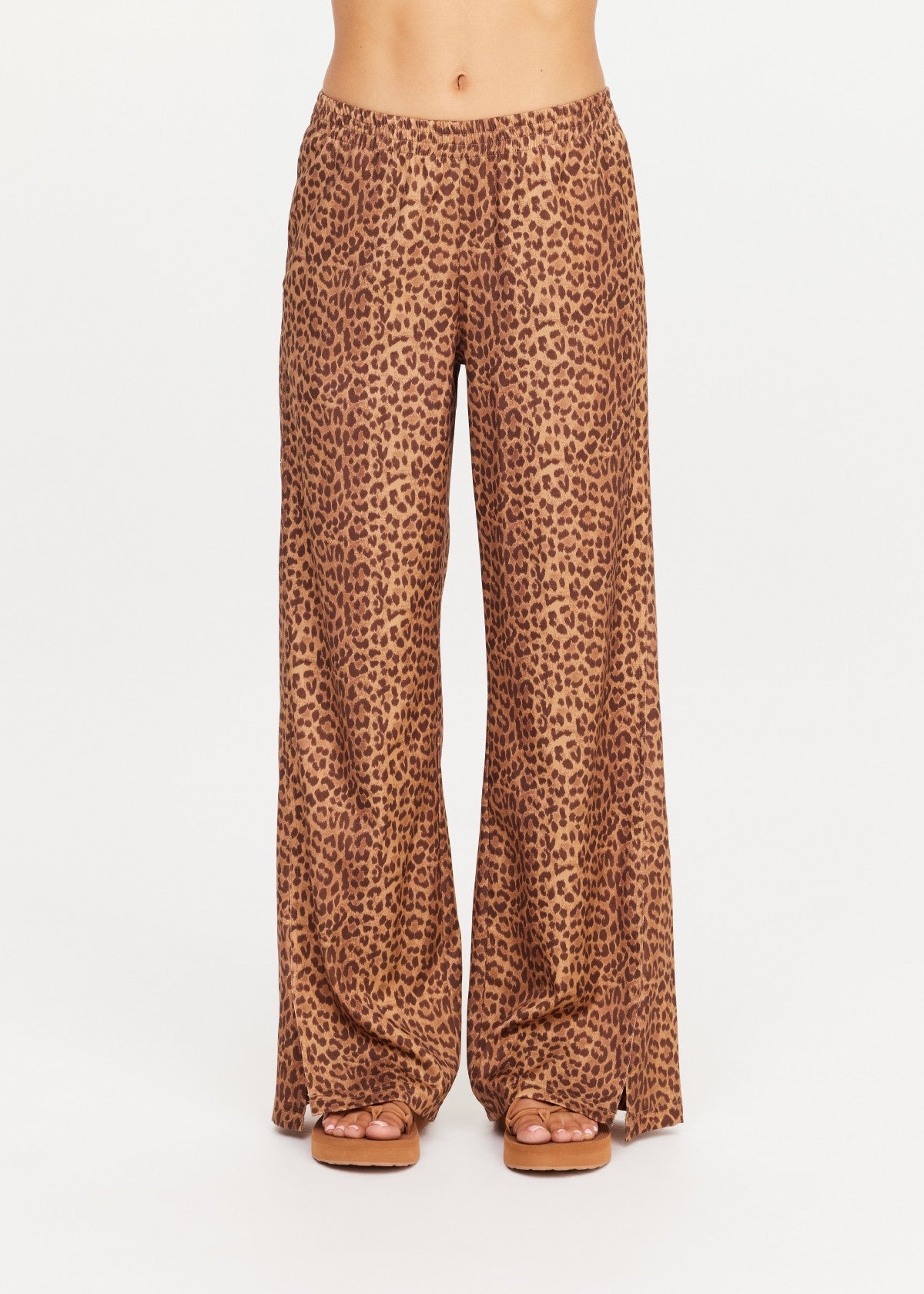 Wide-leg leopard print pants by The Upside with sandals, shown waist to feet on a white background.