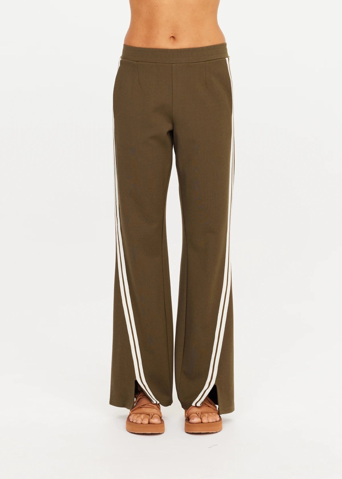 The Upside PETRA FLARE PANT styled with sandals, shown against a bright white background.
