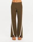 The Upside PETRA FLARE PANT styled with sandals, shown against a bright white background.