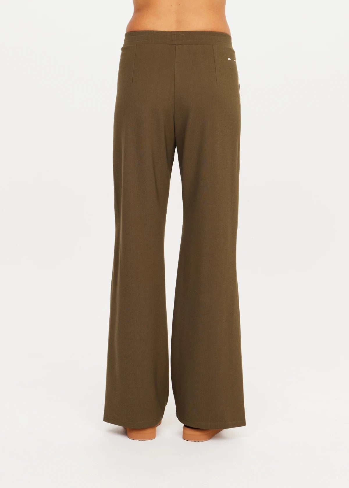 Olive PETRA FLARE PANT by The Upside shown from the back, sleek fit, displayed on white background.