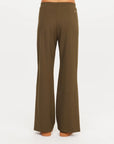 Olive PETRA FLARE PANT by The Upside shown from the back, sleek fit, displayed on white background.