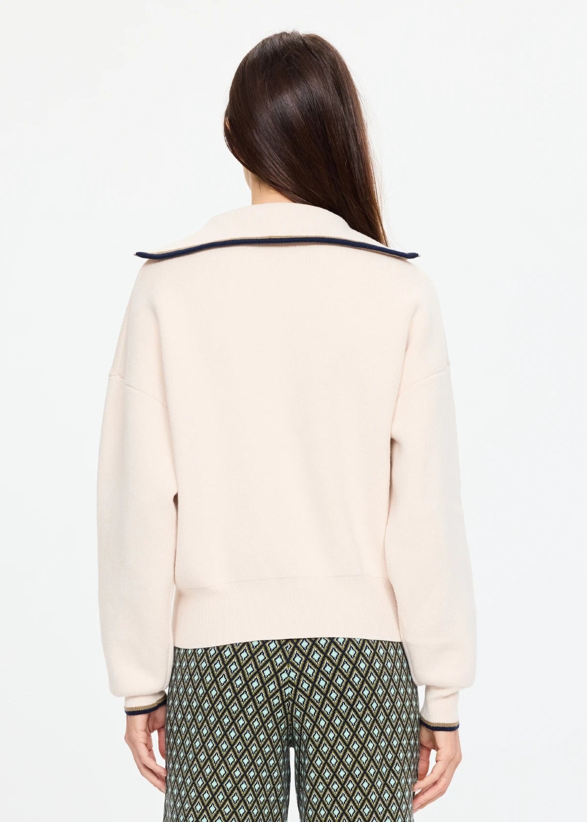 Cream collared cotton jumper and patterned pants by The Upside, KAIRO HALF ZIP KNIT, worn in a relaxed setting.