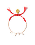 The Venessa Arizaga Bracelet 6" is an adjustable charm piece featuring a red braided string, small white beads, "LOVE" spelled with a heart as the "O," and a round gold charm near the closure.