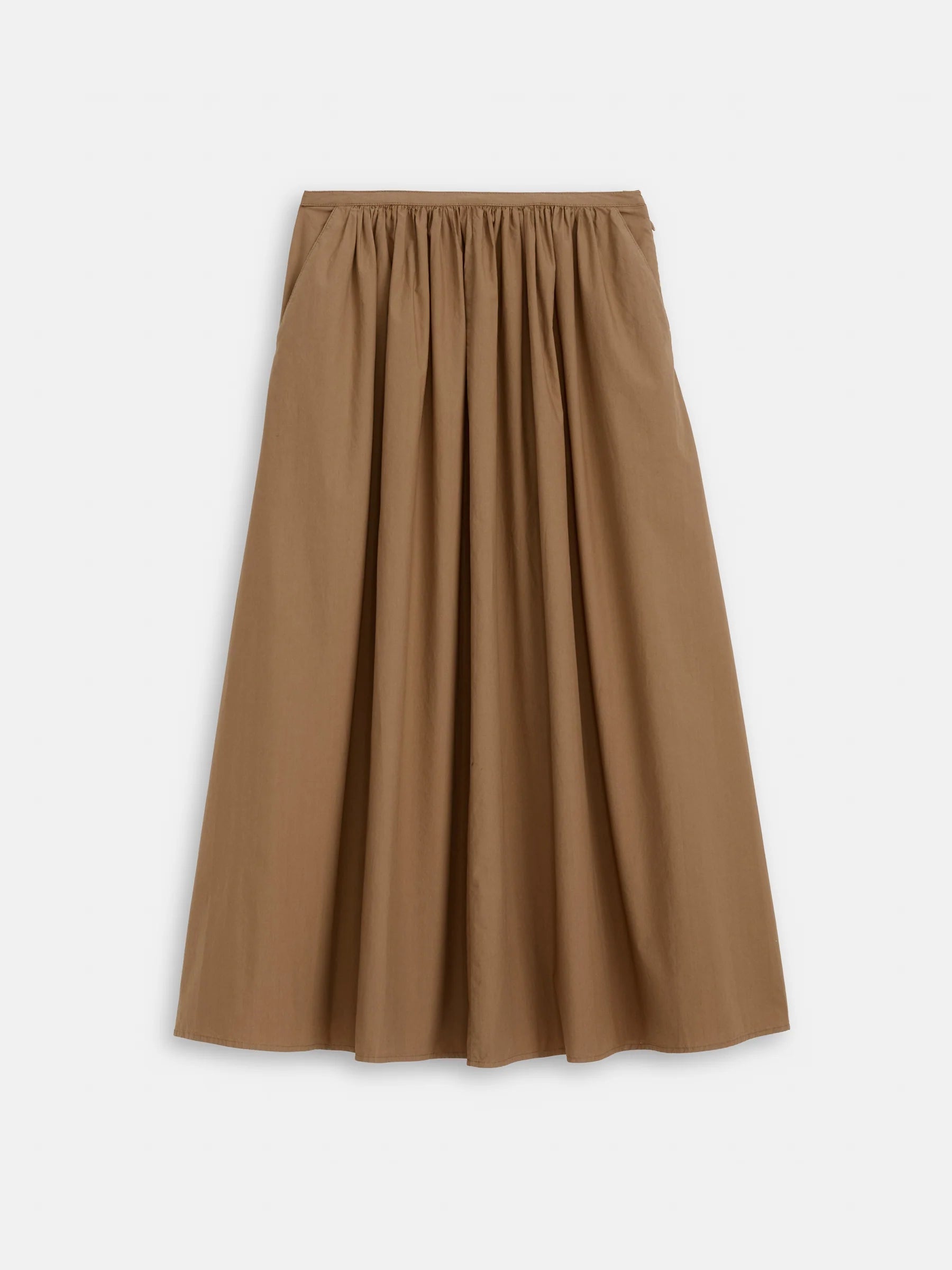 The Alex Mill Sarah Skirt is a tan, ankle-length A-line skirt with a gathered waistband and pockets, made from lightweight fabric, shown on a plain white background.